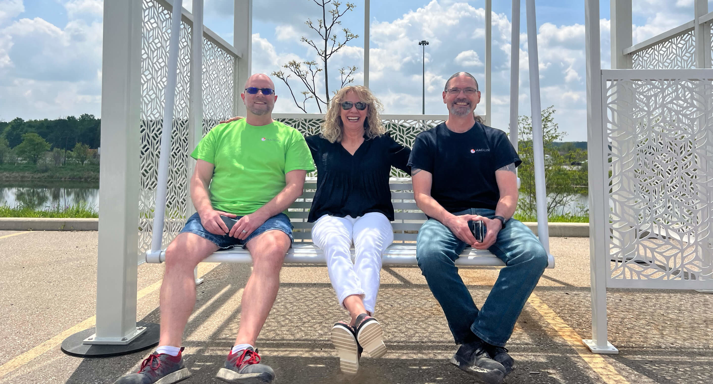 steve-max-mike-maglin-swing Maglin employees, Steve, Max, and Mike sit on a swing in front of Maglin pond.