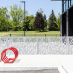 Silver FLEXX panels in front of firehouse and red bike rack