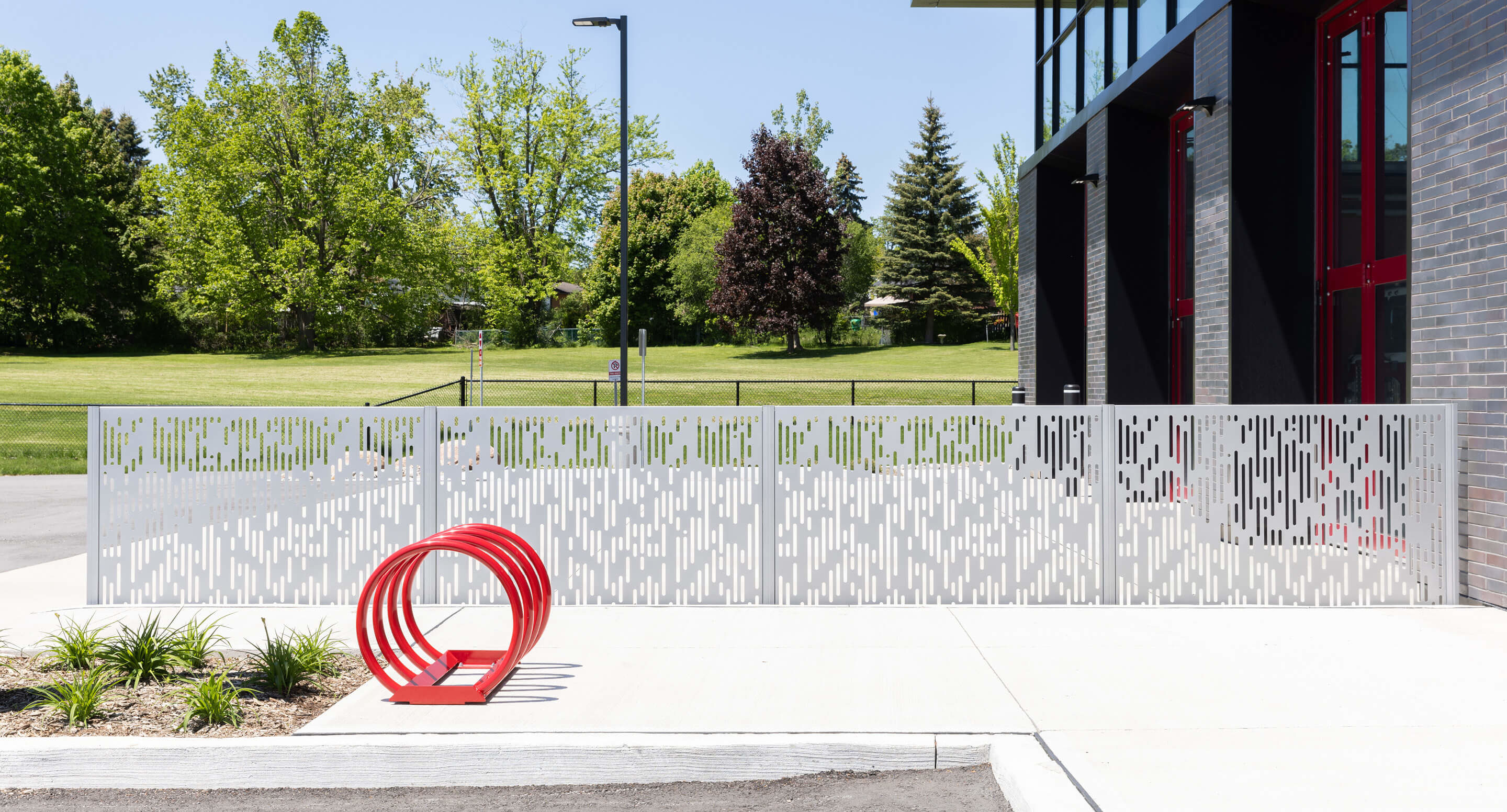 Silver FLEXX panels in front of firehouse and red bike rack